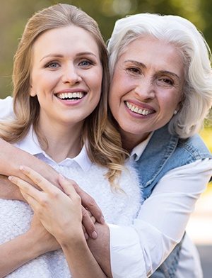 Smiling mother and adult daughter