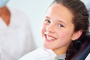 Smiling young woman in dental chair