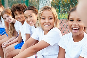 Smiling kids playing baseball